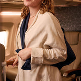 Cozy cream travel jacket with navy accents, perfect for flights, made from soft, comfortable material.