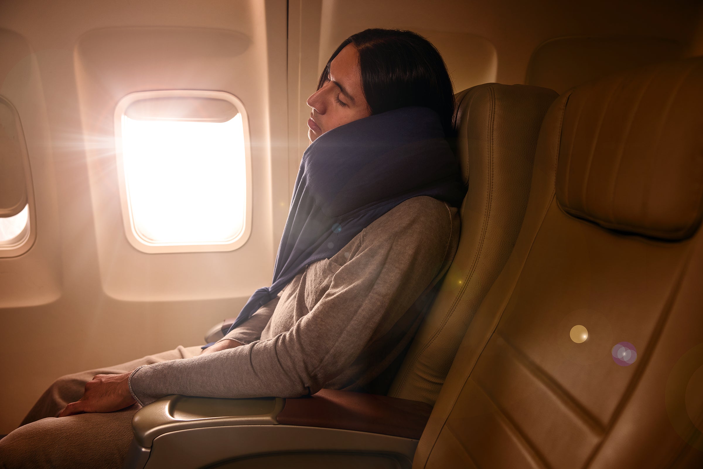 Cozy travel neck pillow in navy, providing comfort for flights; features soft fabric and supportive design.